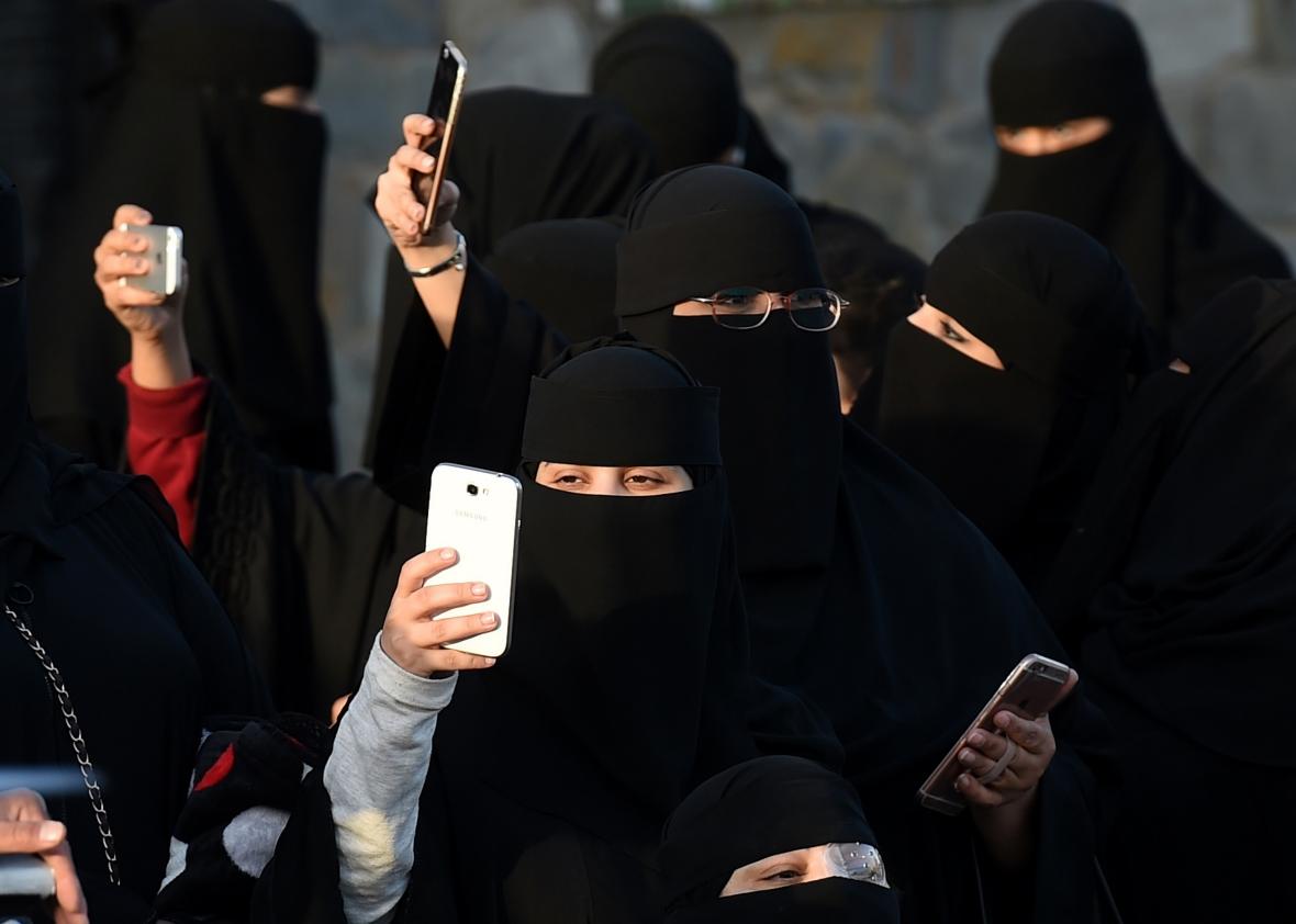 509060880-saudi-women-use-their-mobile-phones-during-the