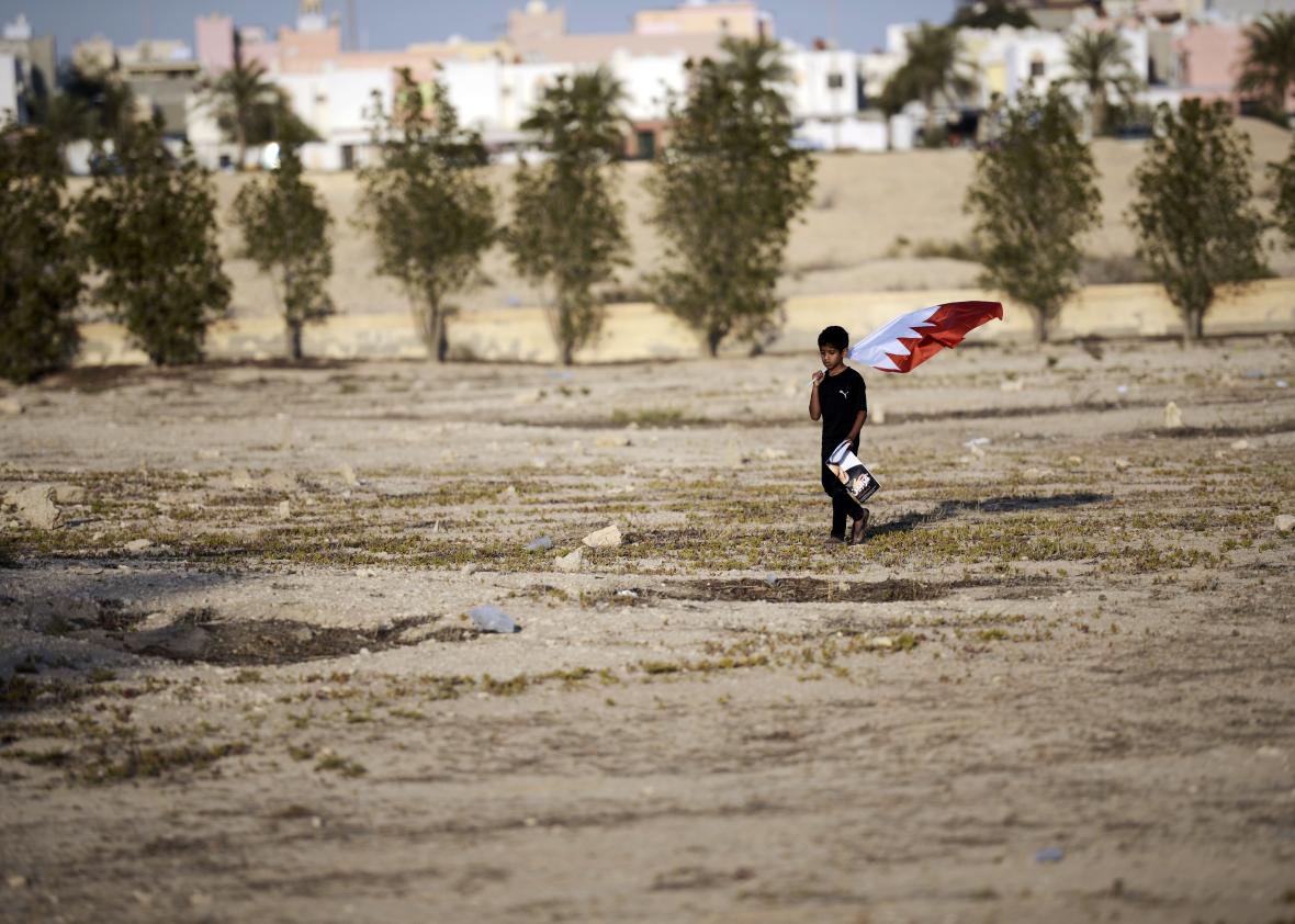 519245608-bahraini-boy-carries-his-national-flag-during-the