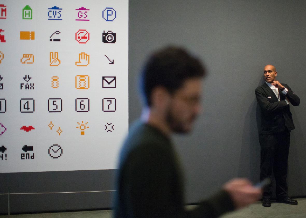 629948134-man-passes-by-a-screen-showing-emoji-characters 629948134-man-passes-by-a-screen-showing-emoji-characters