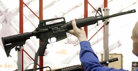 Bill Saxler of Milwaukee holds a Bushmaster rifle in 2006, during the 135th National Rifle Association (NRA) Annual Convention in Milwaukee, Wisconsin. 