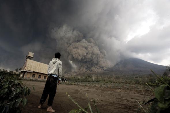 466349703-resident-looks-at-giant-volcanic-ash-clouds-from-a