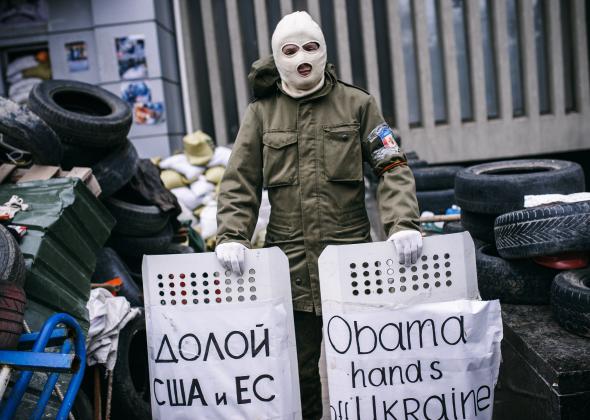 484357413-masked-pro-russia-supporter-stands-guard-outside-the