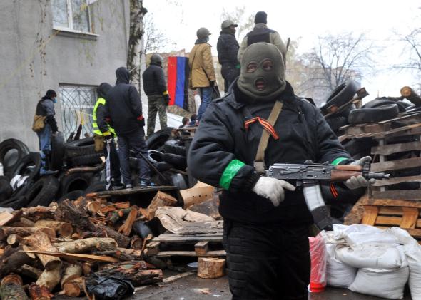 484536145-pro-russia-protesters-guard-a-barricade-outside-a