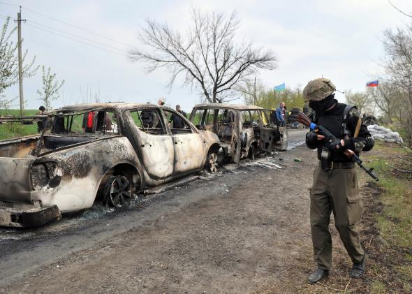 485718315-an-armed-pro-russian-militiants-stands-guard-at-a-check