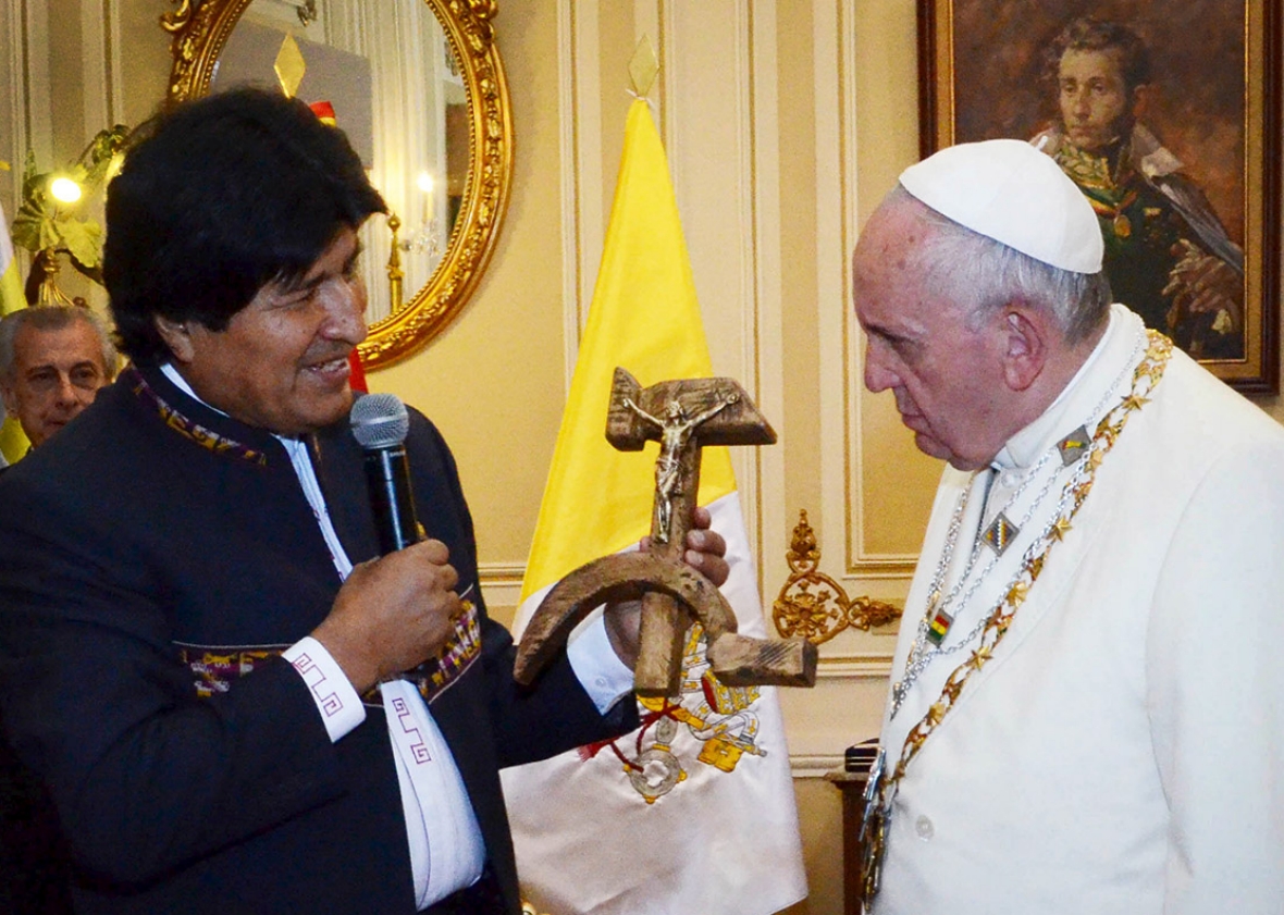 Bolivia's President Evo Morales, left, presents a figure of a cr
