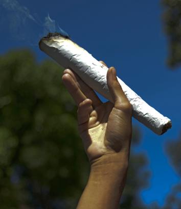 488044041-man-holds-a-giant-marijuana-joint-during-the-world-day