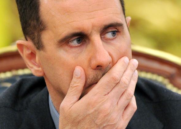 110788705-syrias-president-bashar-al-assad-gestures-as-he-speaks