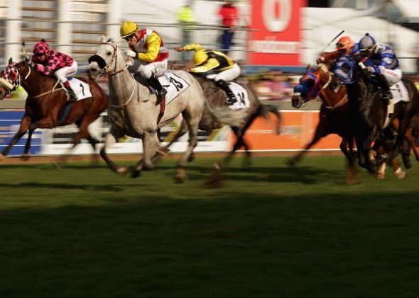 173071686-jockeys-and-their-horses-break-for-the-finish-line