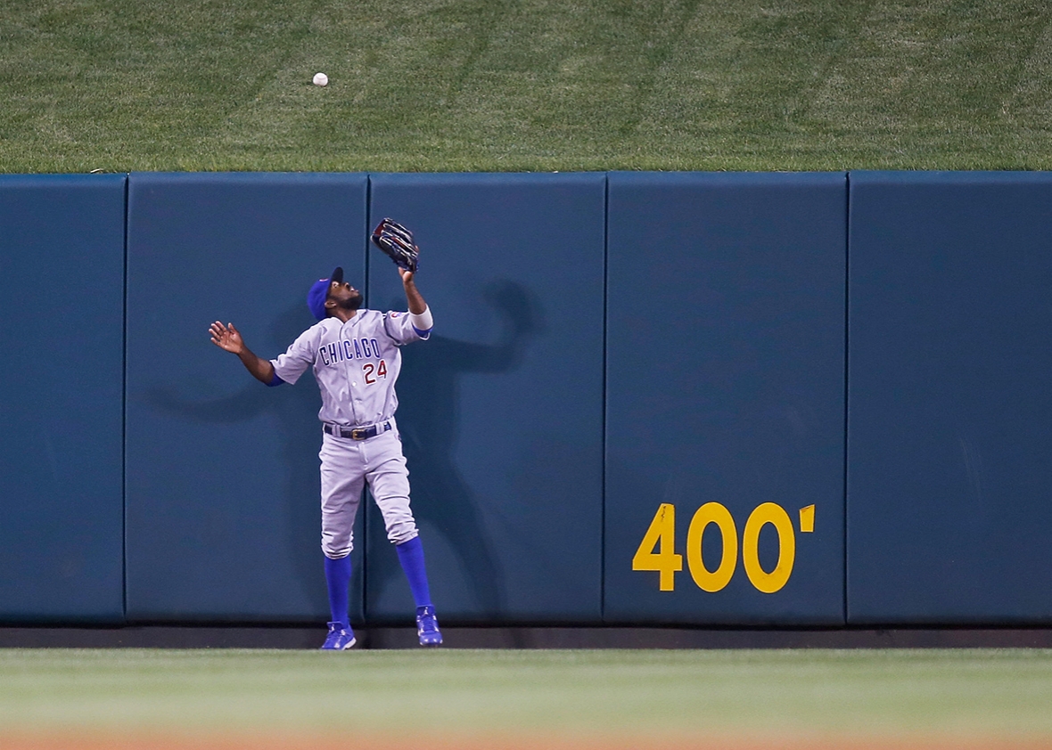 Dexter Fowler #24 of the Chicago Cubs watches as a home run ball hit by Matt Adams #32 of the St. Louis Cardinals lands over the centerfield wall during the seventh inning at Busch Stadium on May 23, 2016 in St. Louis, Missouri.