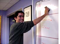 Senior producer Arun Rath smiling through his pain at the Big Board