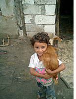 A Roma child holds a dog