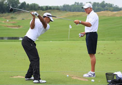 Tiger Woods works on his swing. Click image to expand.