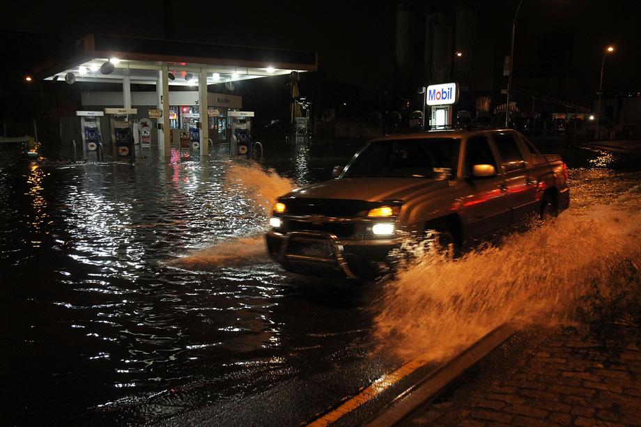 A truck drives by a flooded gas station in the Gowanus section of Brooklyn as Hurricane Sandy affects the area on October 29, 2012 in New York.