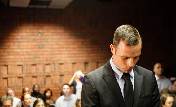 Oscar Pistorius stands in the dock during a break in court proceedings at the Pretoria Magistrates court, Feb. 20, 2013.