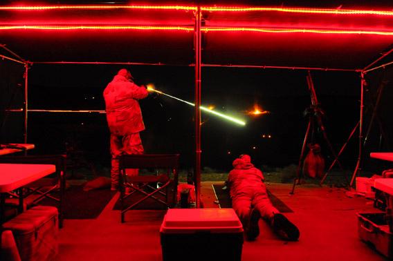 John H Watts loads his machine gun with fresh ammo during a night shoot at the Big Sandy Machine Gun Shoot in March.