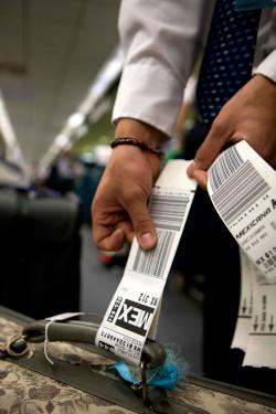 Man showing his baggage tags from Mexicana Airlines to Mexico City.