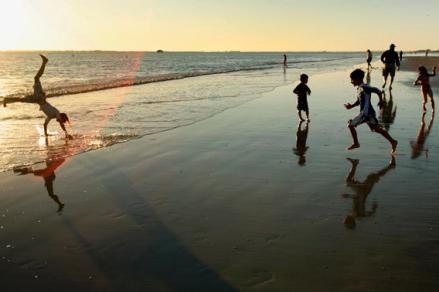 Children play on the beach in Fort Myers, Florida February 19, 2007.  