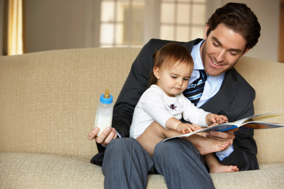 Father reading to daughter (15-18 months).