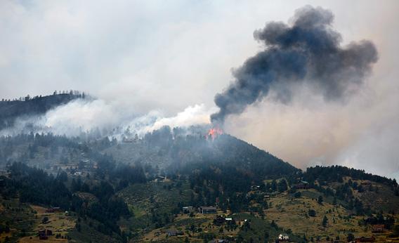Flames and smoke erupt atop a ridge near Horsetooth Reservoir on June 11, 2012 near Laporte, Colorado. 