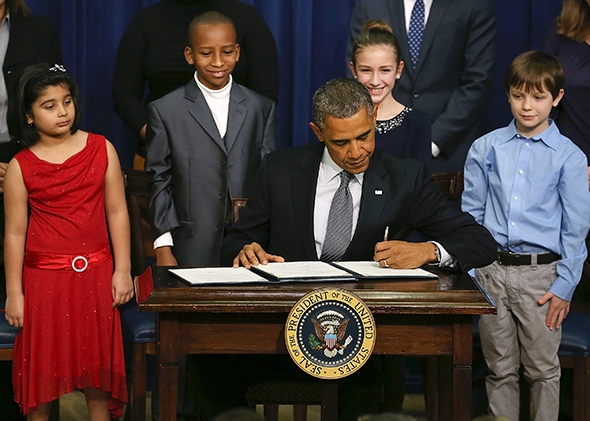 President Obama signs a series of executive orders on new gun-law proposals on Jan. 16 in Washington. 
