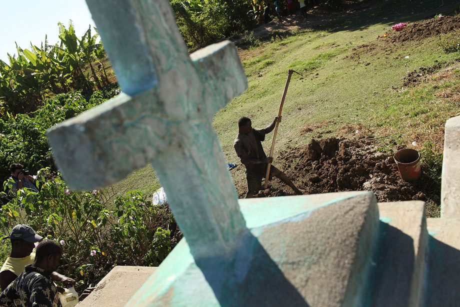 Cemetery workers cover the grave of Serette Pierre, who recently died of cholera, Oct. 29, 2010, in Back D' Aguin, Haiti. Pierre died the same day she contracted cholera, leaving three children without parents. Haiti, one of the poorest nations in the western hemisphere, has been further unsettled by an outbreak of cholera, which has so far killed over 300 people. The epidemic has affected the central Artibonite and Central Plateau regions with 3,612 cases so far on record. Authorities believe the outbreak is contained, but has not yet peaked. There is also fear that the deadly diarrheal disease could migrate to the sprawling camps for the hundreds of thousands of Haitians displaced by the January 2010 earthquake.