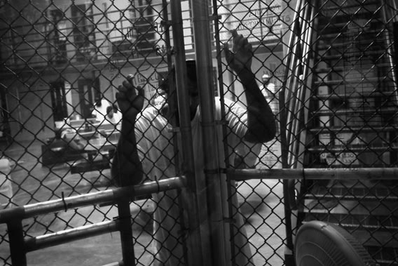 A detainee stands at an interior fence inside the U.S. military prison for &quot;enemy combatants&quot; on October 27, 2009 in Guantanamo Bay, Cuba. 