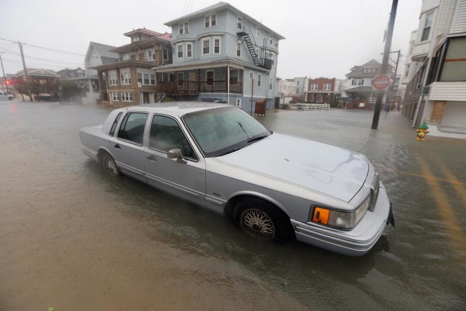 A car sits in a flooded street near the ocean ahead of Hurricane Sandy on Monday in Atlantic City, New Jersey. 