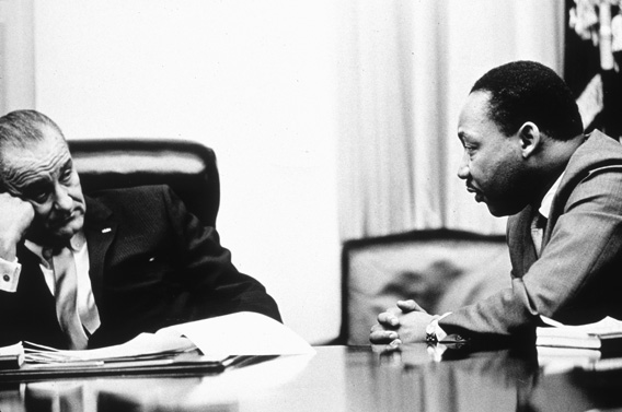 President Lyndon B Johnson (1908 - 1973) discusses the Voting Rights Act with civil rights campaigner Martin Luther King Jr. (1929 - 1968). 