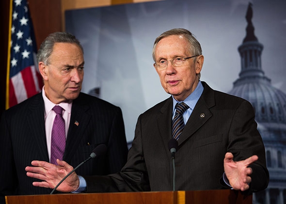 Sen. Chuck Schumer (D-NY) looks on while Senate Majority Leader Harry Reid (D-NV) speaks.