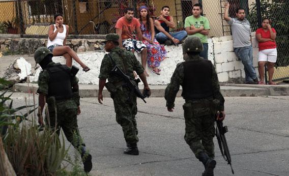 Mexican soldiers near at the site of a suspected drug execution on February 28, 2012 in Acapulco, Mexico. 