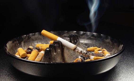 A cigarette burning in an ashtray. 