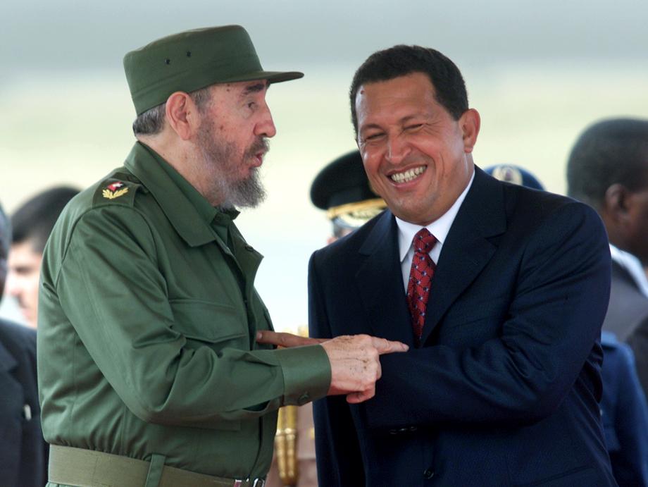  Fidel Castro (L) and Hugo Chavez joke after Castro's arrival at Caracas' Maiquetia airport, October 26, 2000. Castro is in Venezuela for a five day state visit during which he will sign an agreement to purchase subsized oil from Venezuela.  AW - RTR9ZZX
