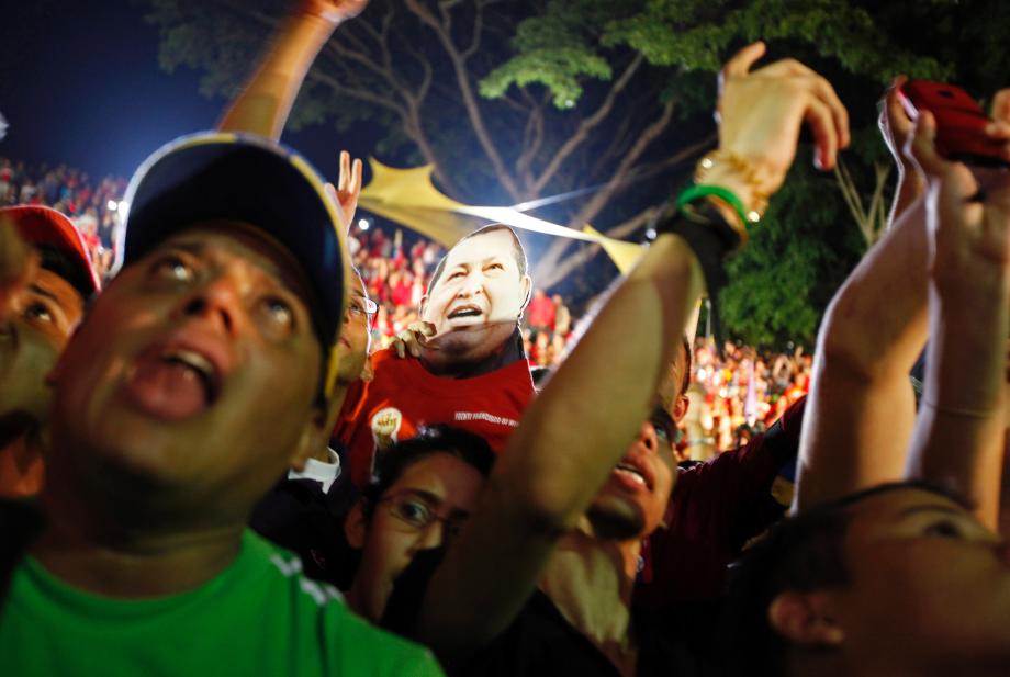 Supporters of Venezuelan President Hugo Chavez cheer as he appears on a balcony of Miraflores Palace in Caracas October 7, 2012. Venezuela's socialist President Chavez won re-election in Sunday's vote with 54 percent of the ballot to beat opposition challenger Henrique Capriles.