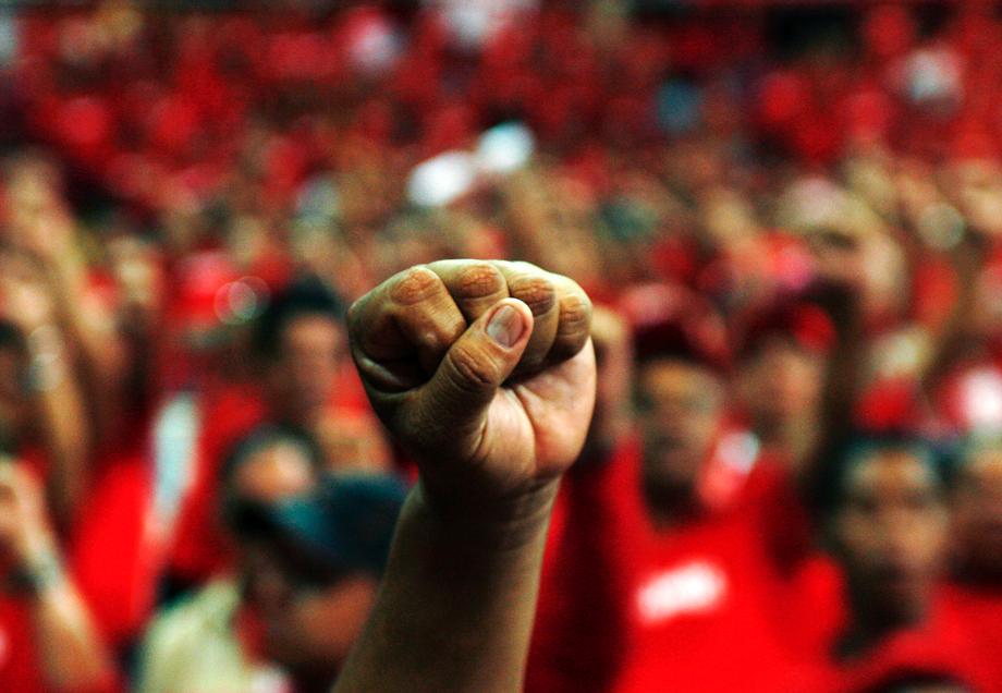 A supporter of Venezuelan President Hugo Chavez raises his left fist at a rally to promote Chavez's new United Venezuelan Socialist Party (PSUV) in Caracas April 19, 2007. 