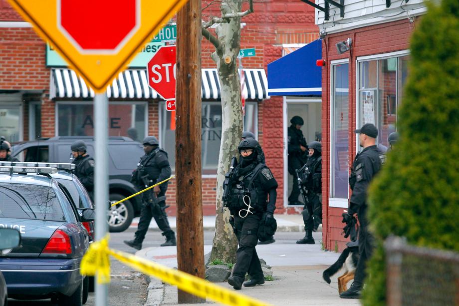 SWAT teams enter a suburban neighborhood to search for the remaining suspect in the Boston Marathon bombings in Watertown, Massachusetts April 19, 2013. Two Boston bomb suspects were named as brothers, Dzhokhar A. Tsarnaev, 19, and his brother Tamerlan Tsarnaev, 26, a U.S. national security official said on Friday. The official said the older brother died in a shootout with police and the younger one was being sought in a house-to-house search for in the Boston suburb of Watertown.