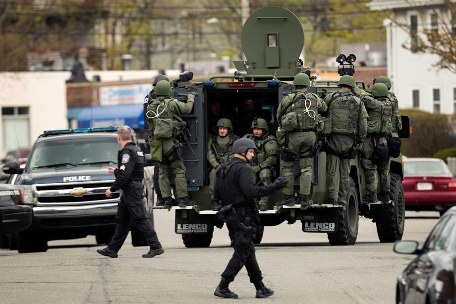Law enforcement officers in tactical gear enter the search area for Dzhokar Tsarnaev, the one remaining suspect in the Boston Marathon bombing, in Watertown, Massachusetts April 19, 2013. 