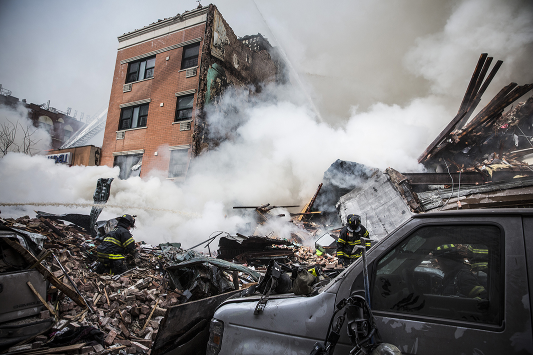 Heavy smoke pours from the debris at the site of a building collapse at Park Avenue and East 116th Street.