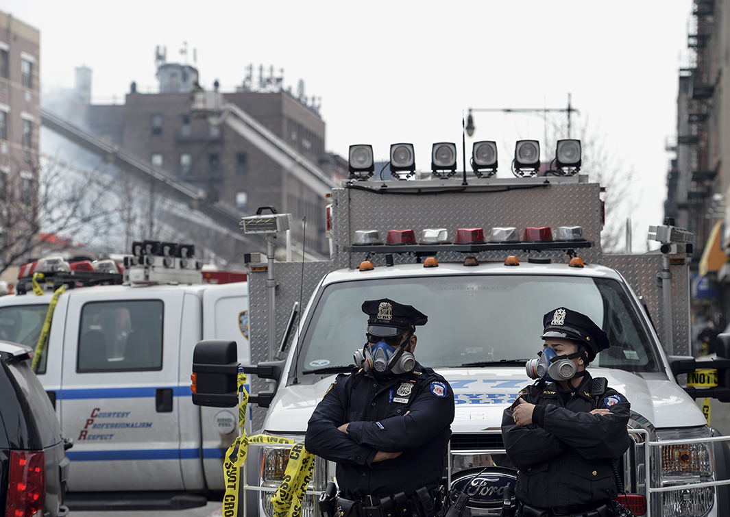 New York City Police Department officers wear masks at the scene of the explosion.