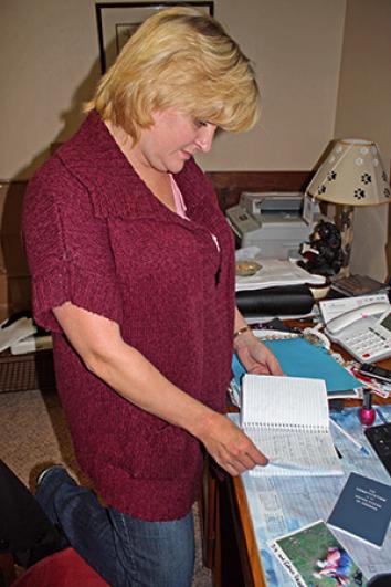 Kathy Smith reviews notes on her son&rsquo;s case in her home