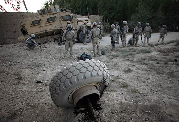 U.S. soldiers inspect damage to their armored vehicle after an near the village of Eber in Logar province, Afghanistan, on Sept. 26, 2009.