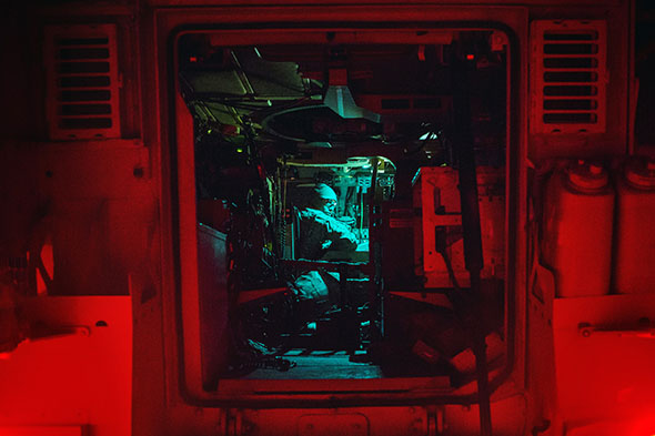 A U.S. soldier sits in an MRAP vehicle as he prepares for an early morning mission at Forward Operating Base Fenty in Afghanistan on Dec. 19, 2014.