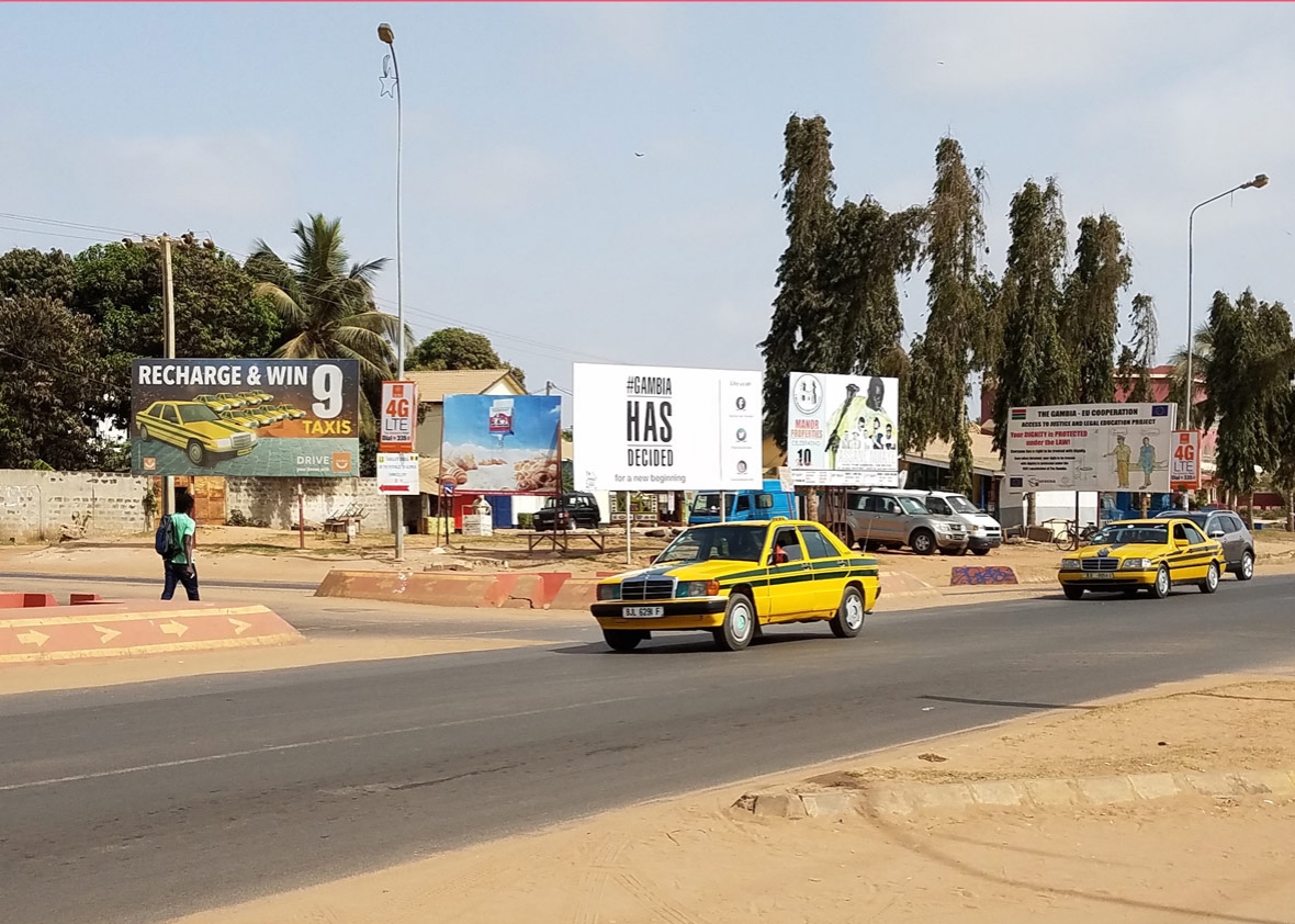 Billboards line the highway near Senegambia beach, a coastal area popular with foreign tourists.