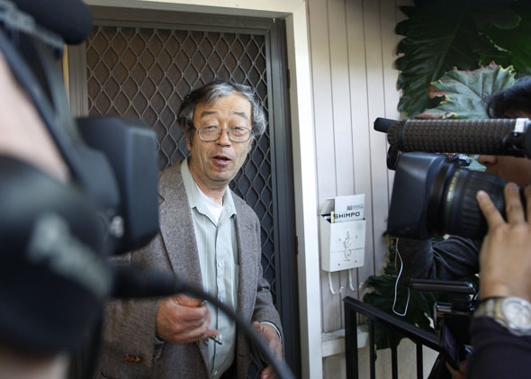 Dorian Nakamoto, widely believed to be Bitcoin currency founder, is surrounded by reporters as he leaves his home in Temple City, California March 6, 2014.