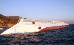 A photograph taken early on January 14, 2012 of the Costa Concordia after the cruise ship with more than 4,000 people on board ran aground and keeled over off the Isola del Giglio, Italy.