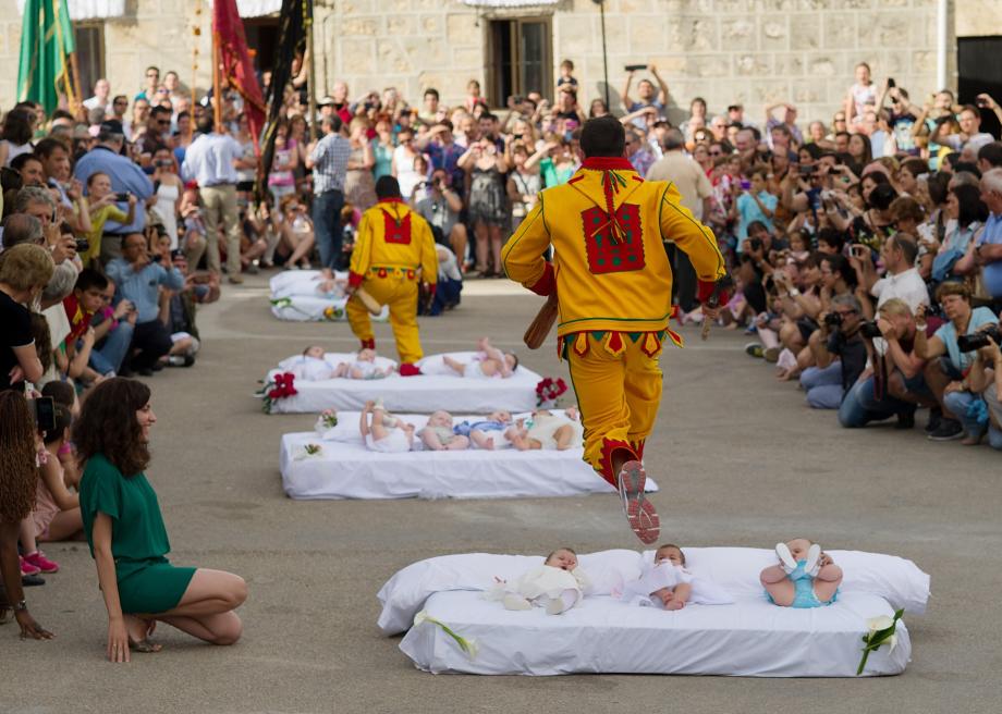 451047342-man-representing-the-devil-leaps-over-babies-during-the 451047342-man-representing-the-devil-leaps-over-babies-during-the