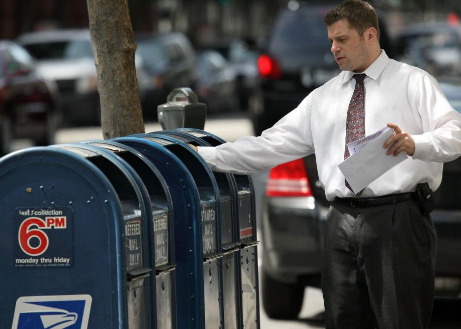 87066598-man-drops-letters-into-a-mailbox-may-11-2009-in-san