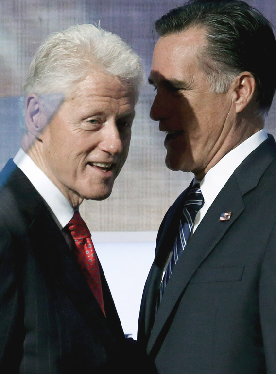  Former U.S. President Bill Clinton stands with Republican presidential candidate Mitt Romney.