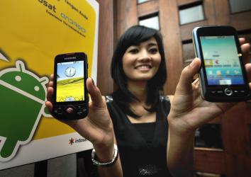 A model displays smartphones with Google's mobile operating system Android during its first launch in Jakarta on Feb. 22, 2010.