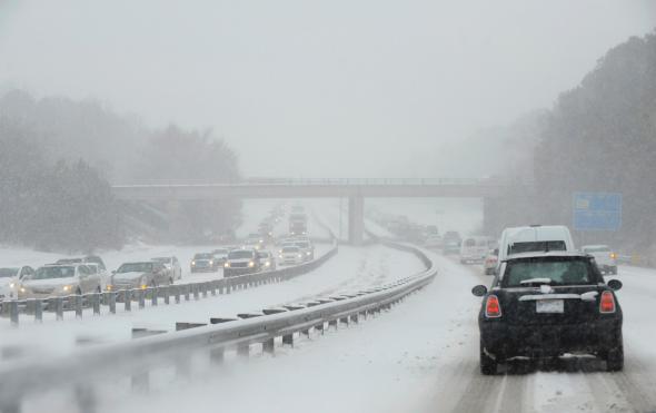 Traffic on Durham Freeway 147 creeps along as compacted snow turns into ice on February 12, 2014 in Durham, North Carolina.