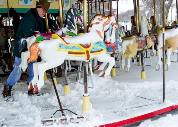 479272501-worker-clears-snow-from-the-carousel-on-the-national